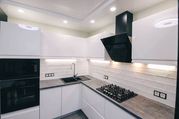 istock interior of a modern compact white kitchen with gas stove, oven, refrigerator. built-in furniture household appliances 1141405923