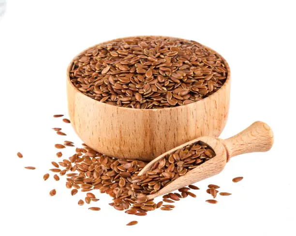 Flax seeds isolated on white background with clipping path, close-up of linseed in wooden scoop and bowl