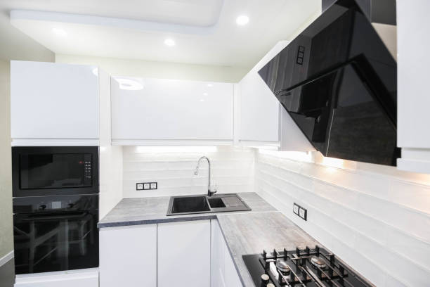 istock interior of a modern compact white kitchen with gas stove, oven, refrigerator. built-in furniture household appliances 1141406206