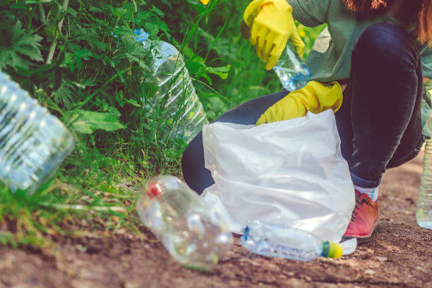 istock Volunteer collects plastic bottles outdoors 1141406859
