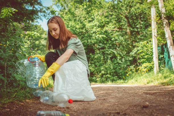 istock Volunteer collects plastic bottles outdoors 1141406881