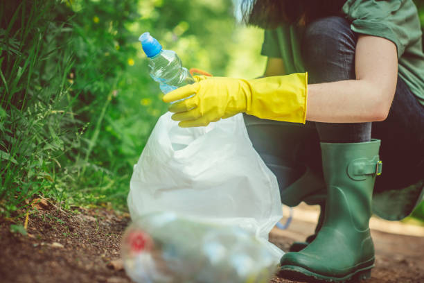 istock Volunteer collects plastic bottles outdoors 1141406891