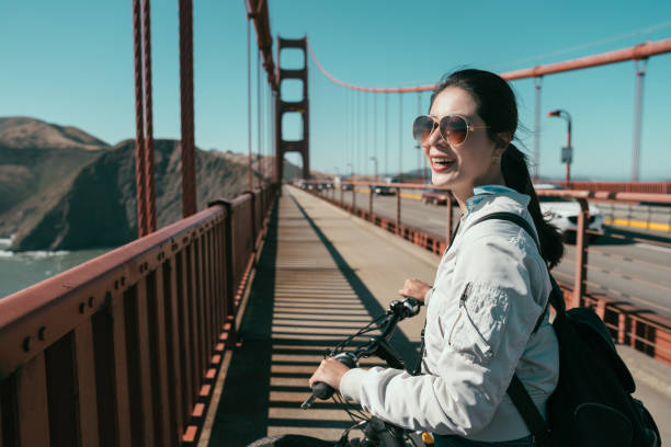 istock girl backpacker walk with bicycle on pedestrian 1141407126