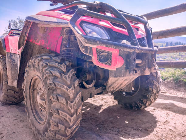 istock red quad bike on a dirt road, close-up, side and front view 1141408430