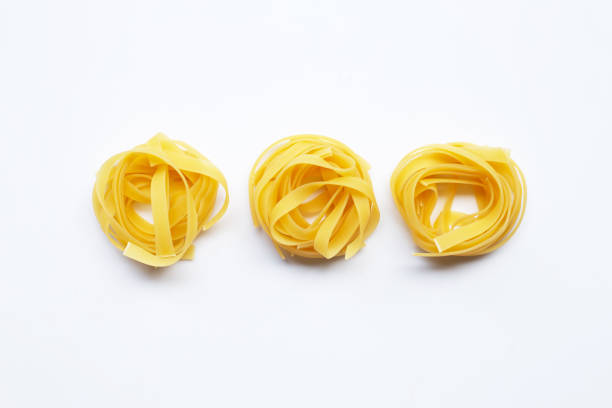 istock Uncooked Italian pasta tagliatelle nest on white background 1141415021