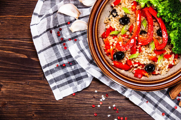istock Groats and vegetables on wooden table 1141415429
