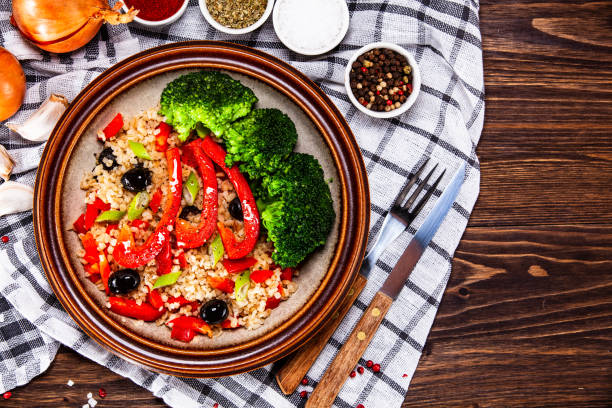 istock Groats and vegetables on wooden table 1141415666