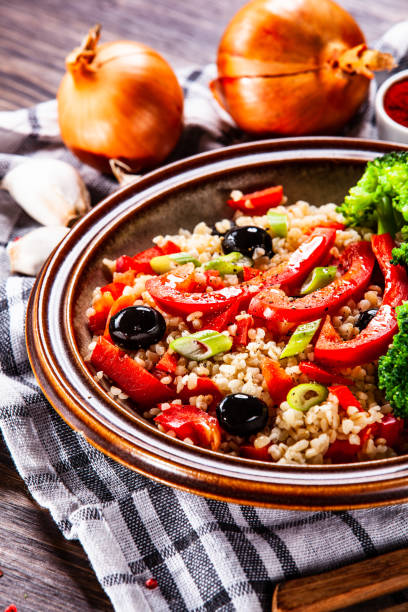 istock Groats and vegetables on wooden table 1141415950