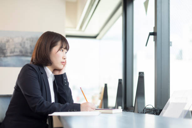 istock Woman sitting at desk and working 1141416117