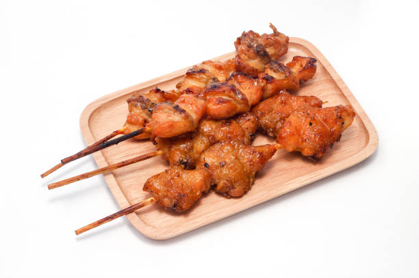 istock Chicken butt grilled on wooden plate isolated on white background 1141416130