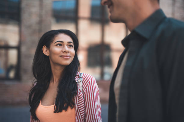 istock Long haired woman smiling while looking at boyfriend 1141417289