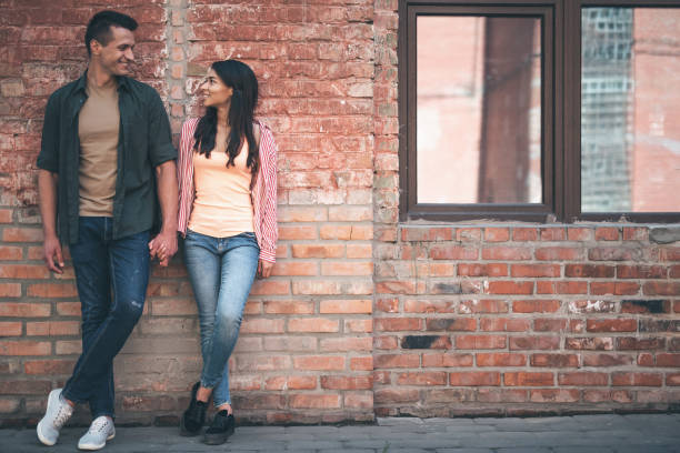 istock Good looking couple holding hands and smiling to each other 1141417339