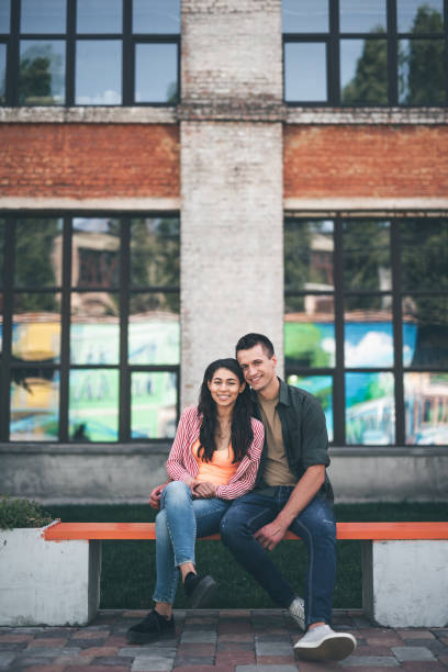 istock Happy man hugging his girlfriend while sitting on the bench 1141417346