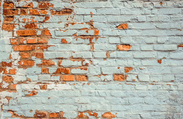istock Old Brick Wall White Painted Texture. Shabby Building With Damaged cracked Plaster 1141418729