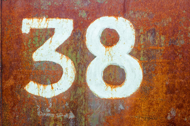 istock Texture of completely rusty metal with number thirty eight drawn by white paint 1141418982