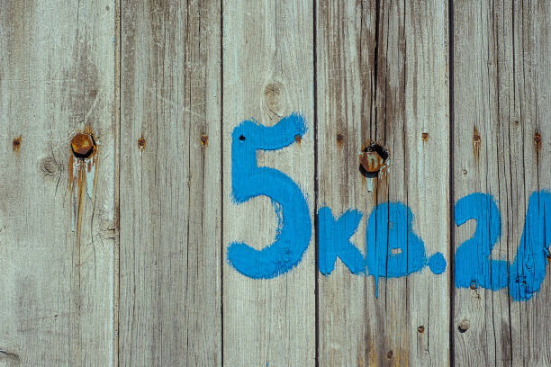 istock Nuber Five Drawn by blue paint on wood old fence 1141419240