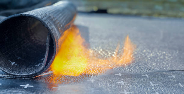 istock Heating and melting of bitumen rolls 1141421911