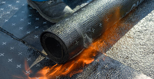 Heating and melting of bitumen rolls Construction worker heating and melting bitumen rolls. waterproof photos stock pictures, royalty-free photos & images