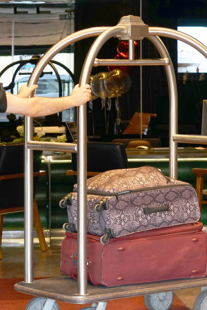 hotel baggage cart Close-up many suitcases on hotel luggage cart moving by bell boy. Baggage porter or bell boy bringing the suitcase of guests with a box van to the hotel room. Trolley Luggage at the hotel. airport porter stock pictures, royalty-free photos & images