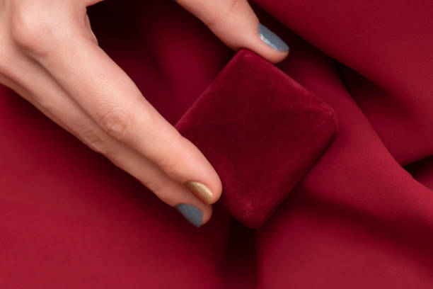 istock Red gift box in female hand, close up. 1141422832