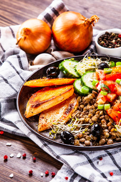 istock Groats and vegetables on wooden table 1141422927