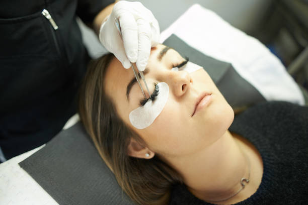 I’m achieving those perfect lash goals Cropped shot of a young woman getting eyelash extensions false lashes stock pictures, royalty-free photos & images