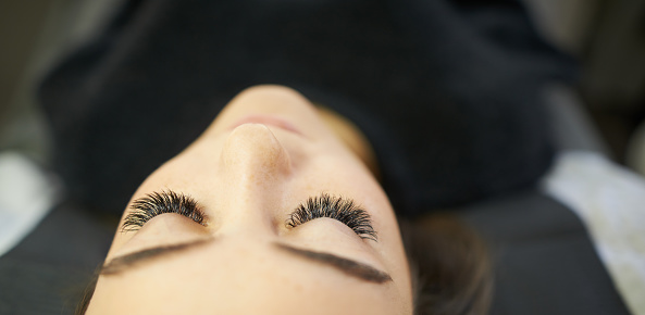 Cropped shot of a young woman getting eyelash extensions