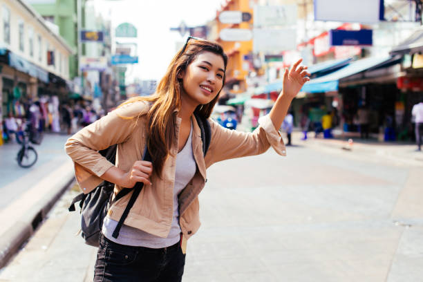 istock Young woman calling a cab in the city 1141425934