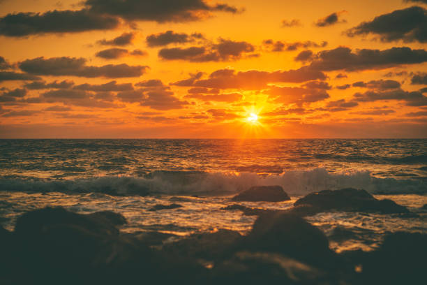 Beautiful sunset at the sea with rocky coastline