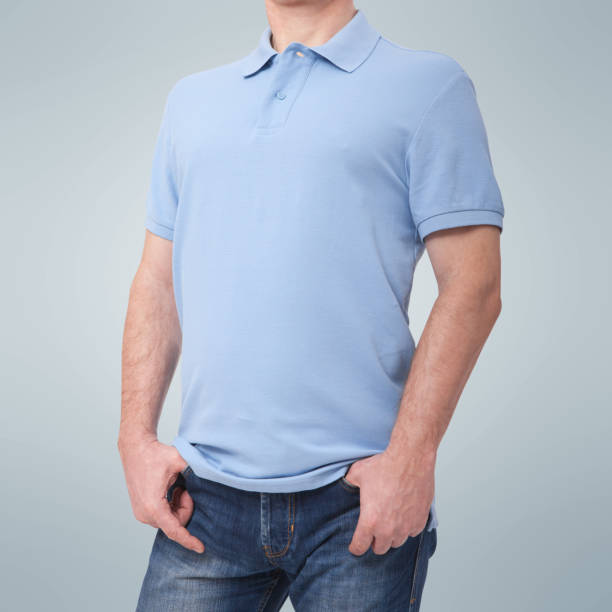 istock Man wearing blank blue t-shirt isolated on white background with copy space. Tshirt design and people concept - close up of men in blank shirt. For mock up template design. Front view 1141430548