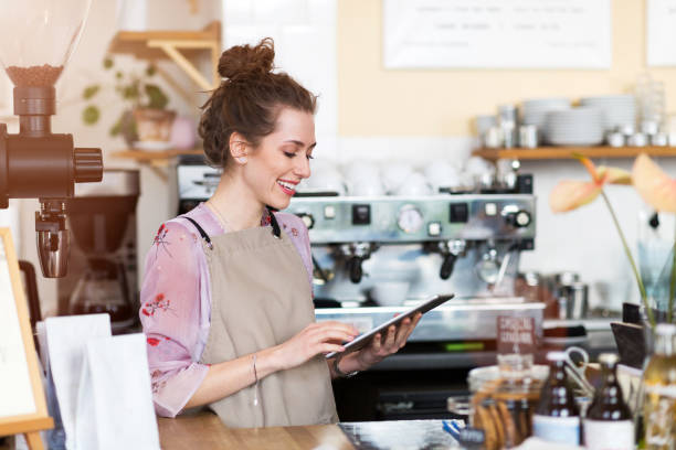 istock Young woman using digital tablet in coffee shop 1141431258
