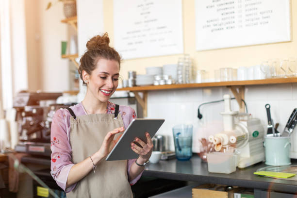 istock Young woman using digital tablet in coffee shop 1141431269