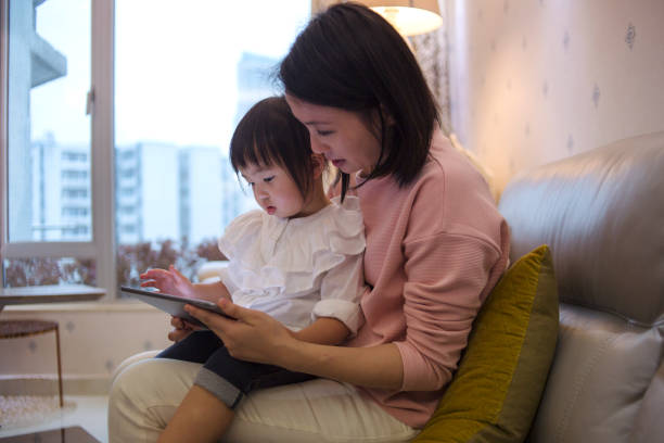 istock young asian mother educating daughter using latest technology from digital tablet 1141432254