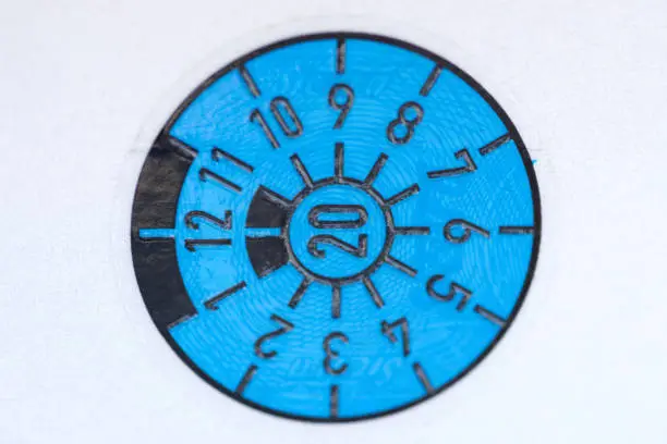 Close-up of a blue TÜV badge