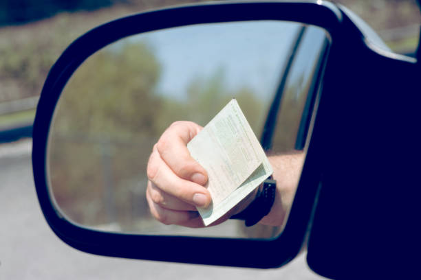 istock A Man shows his Vehicle License during a Check 1141432801