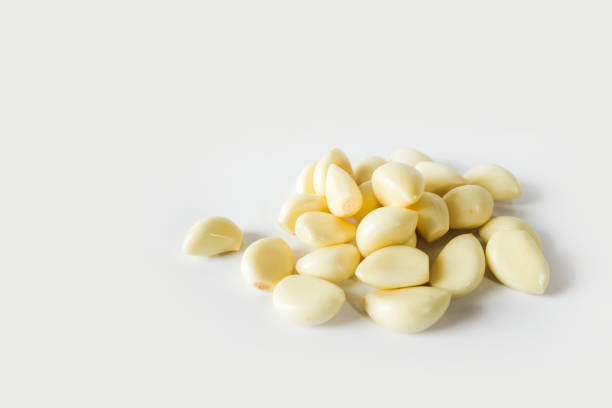 istock Garlic cloves on the white color background 1141432859