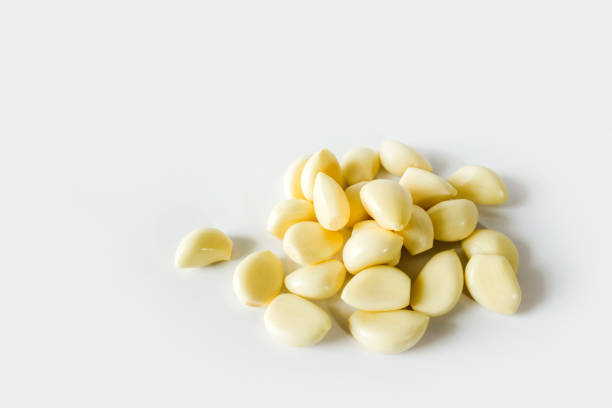 istock Peeled cloves of garlic on white background 1141432877