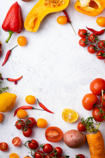 istock Flatlay with colorful vegetables and copy space arranged on white background. Tomatoes, squash and peppers. Frame shape with space in centre. Vegan nutrition concept 1141433718
