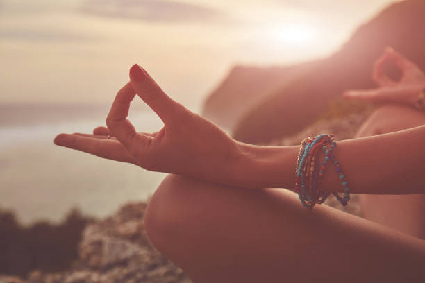 istock Young woman practicing yoga - meditation on the beach. 1141434124