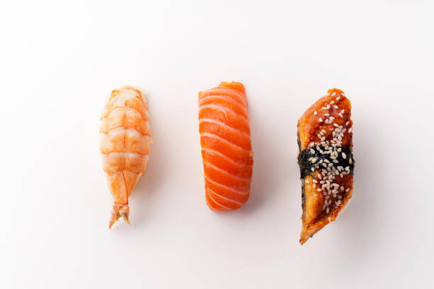 creative layout with various sushi on white background. shrimp, eel, salmon. - susi imagens e fotografias de stock