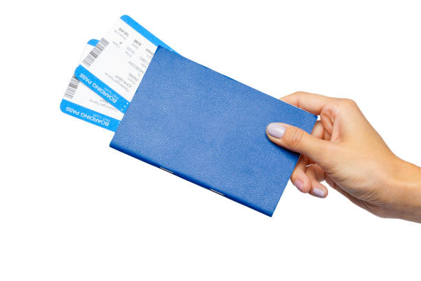 Hand holding passport isolated on white