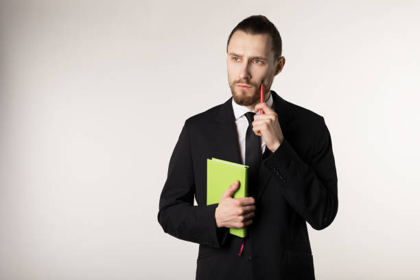 istock Attractive bearded middle manager is thinking how to solve the problem posed by the boss 1141437126