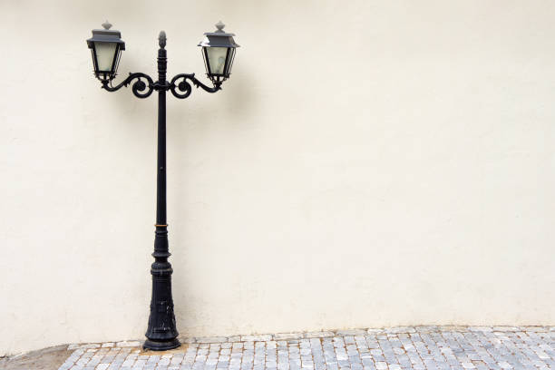 street electric lamp post at white wall