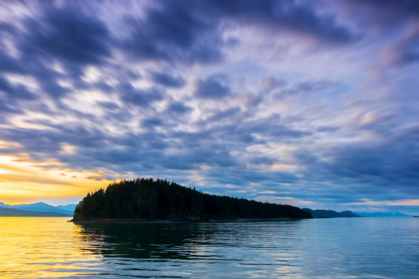 istock Alaskan Sunset, Sea, Island and Distant Mountains 1141437624