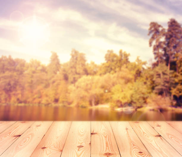 istock Empty table over blurred trees and river as background, product display template 1141438750