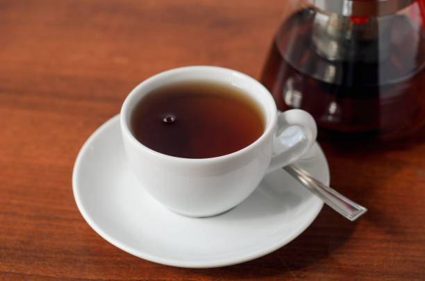 istock White cup of tea on a wooden table. Tea party concept, break. 1141440826
