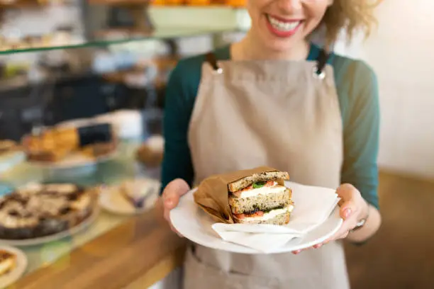 Photo of Waitress ready to serve food in cafe