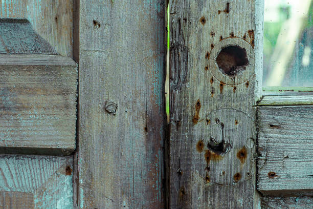 szare drewniane drzwi z otworami od zamka i zardzewiałe plamki z gwoździ. pozioma tekstura grunge - wood shutter rusty rust zdjęcia i obrazy z banku zdjęć