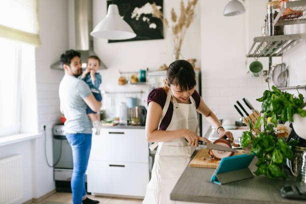 Asian woman using the help of the digital cookbook