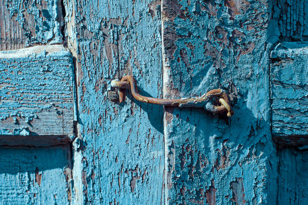istock Rusty metal latch on wood blue shutter cracked and scratch. Horizontal grunge texture 1141442483